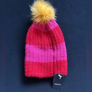 Hat Attack women’s Striped Pom Beanie in Pink, Red & Yellow